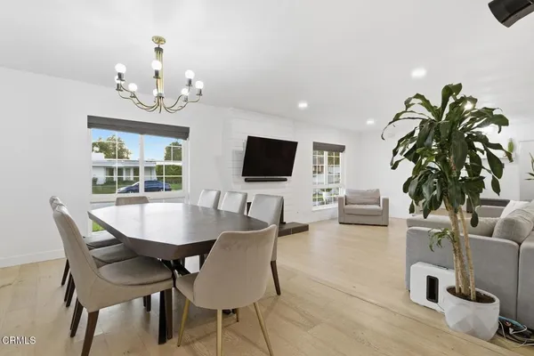 a view of a dining room with furniture window and wooden floor