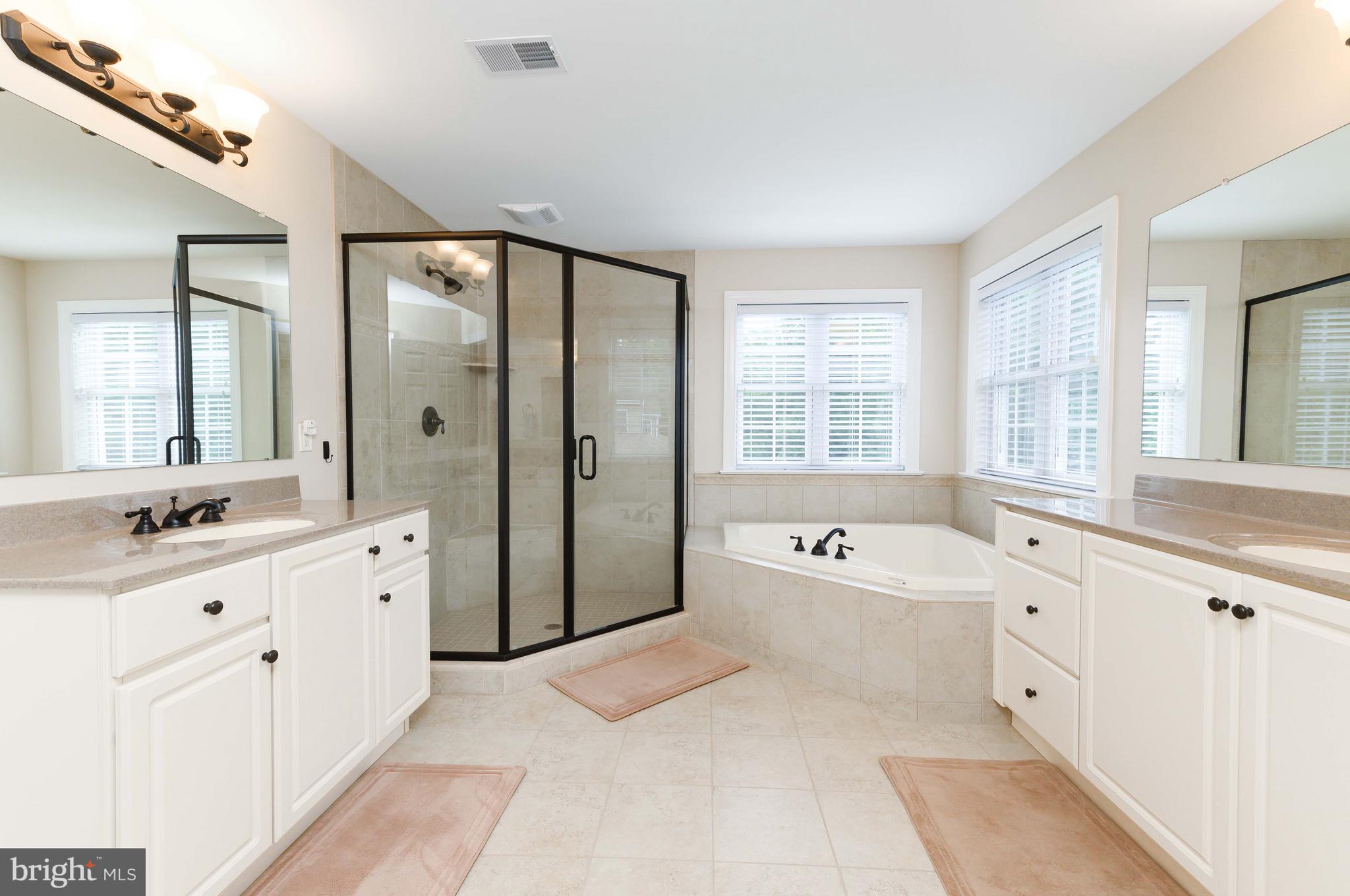 128 Harrogate Drive Landenberg, PA 19350 - Photo 31 of 52 a spacious bathroom with a double vanity sink large mirror and a bathtub