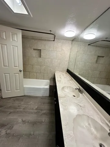 a bathroom with a bathtub and a shower