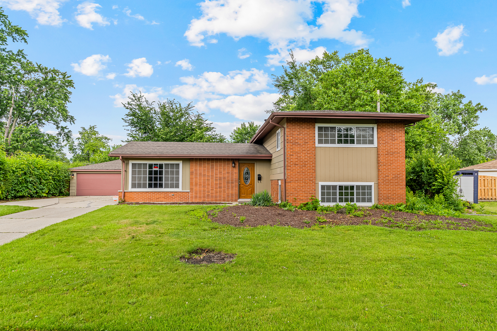 303 Springfield Street Park Forest, IL 60466 - Photo 1 of 16 a front view of a house with a yard and trees