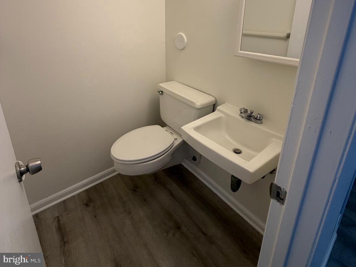 5485 Harpers Farm Road, Unit L3 Columbia, MD 21044 - Photo 11 of 24 a white toilet sitting next to a white sink