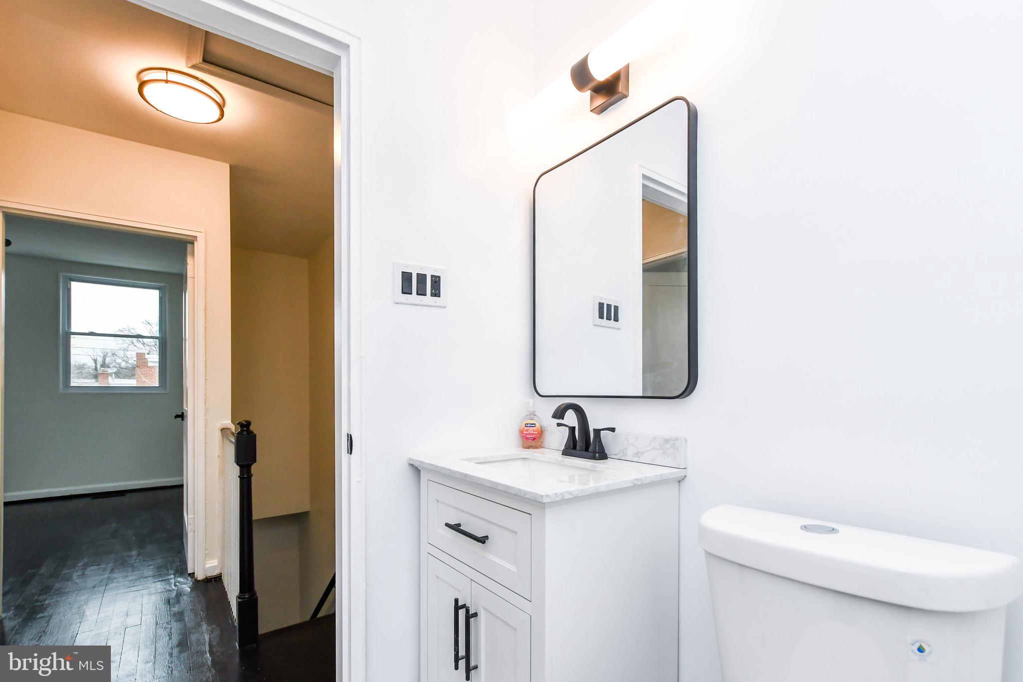 4227 Nash Street Southeast Washington, DC 20020 - Photo 15 of 50 a bathroom with a toilet sink and mirror