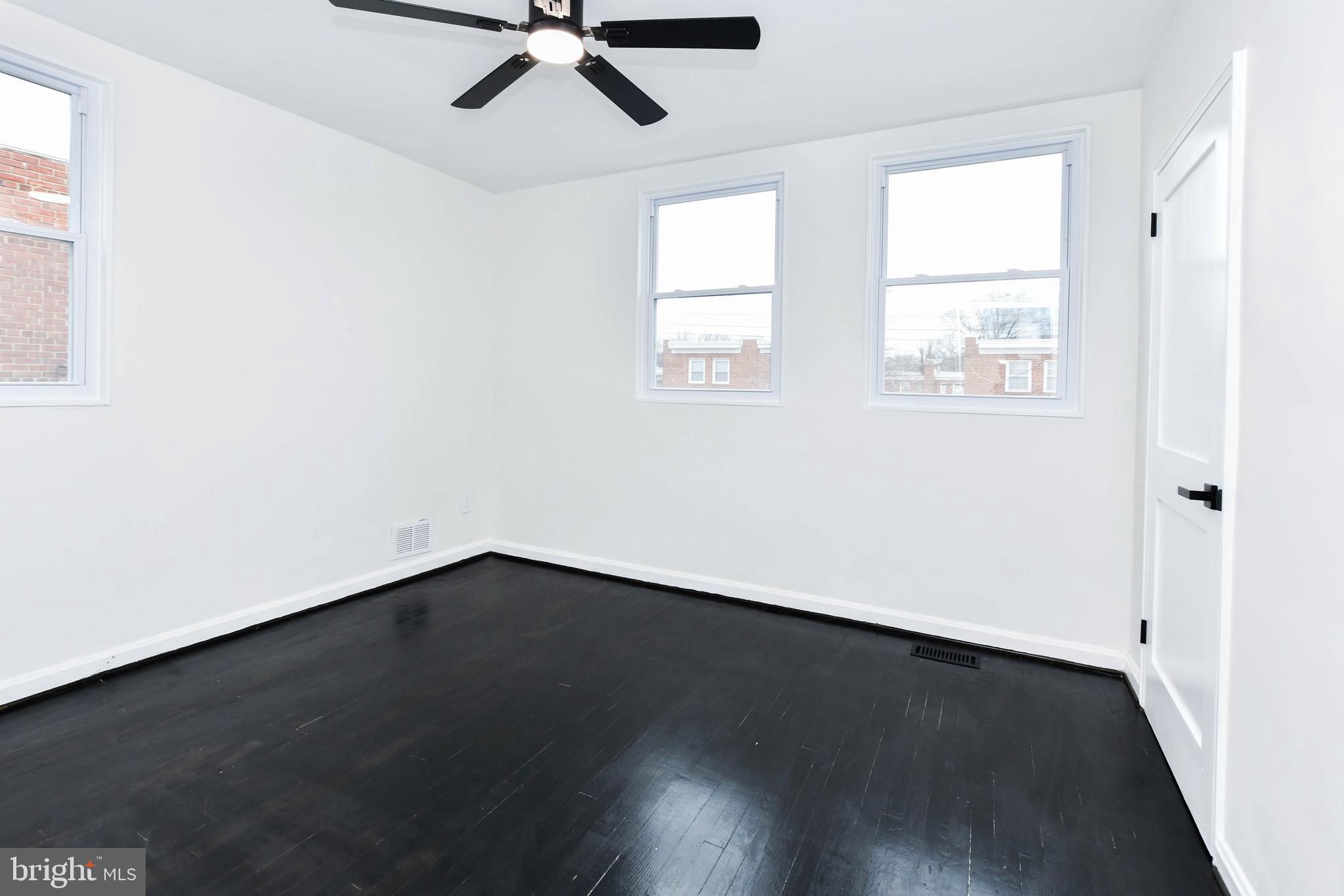 4227 Nash Street Southeast Washington, DC 20020 - Photo 17 of 50 an empty room with wooden floor fan and windows