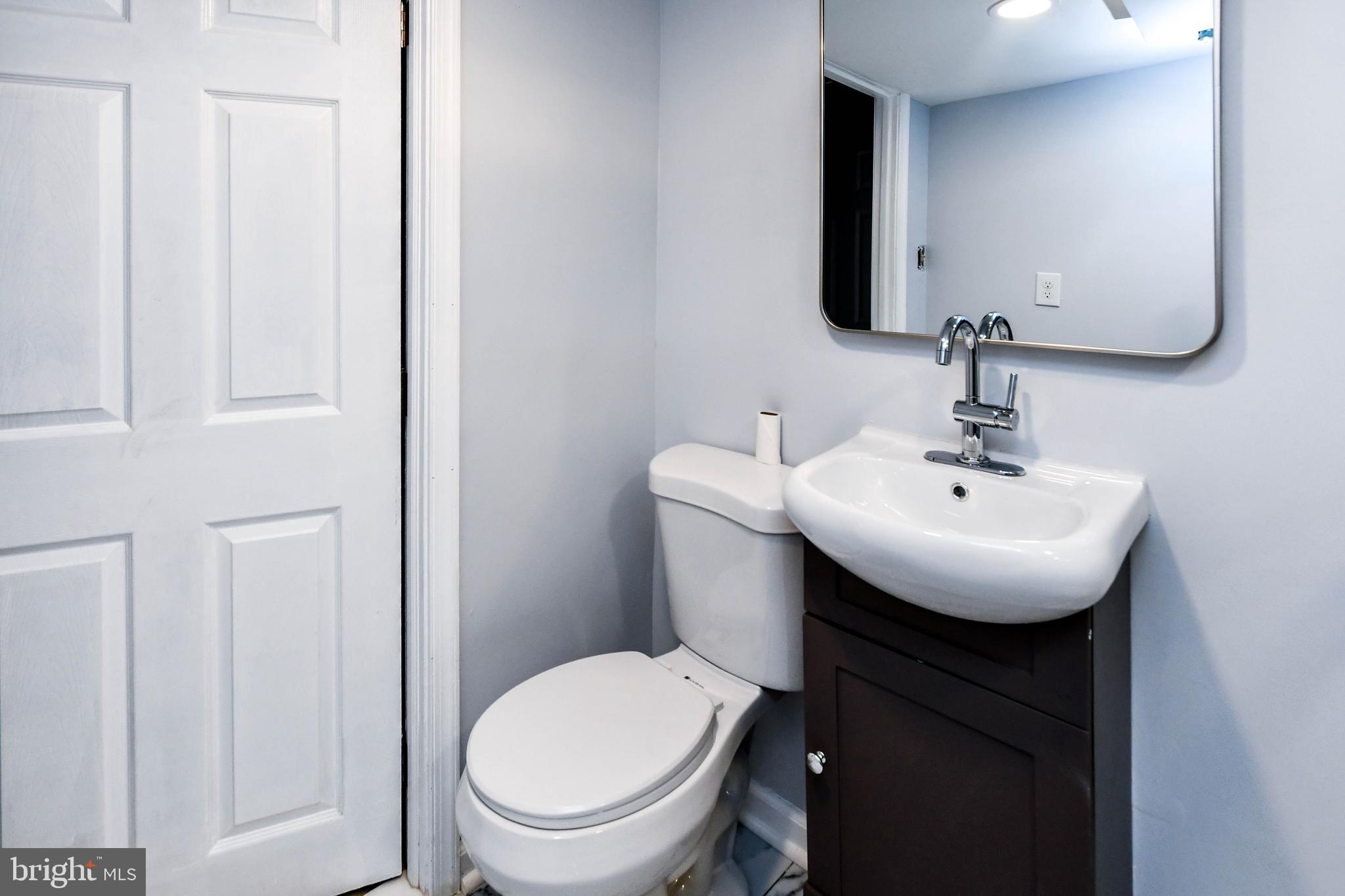 4227 Nash Street Southeast Washington, DC 20020 - Photo 27 of 50 a bathroom with a toilet a sink and a mirror