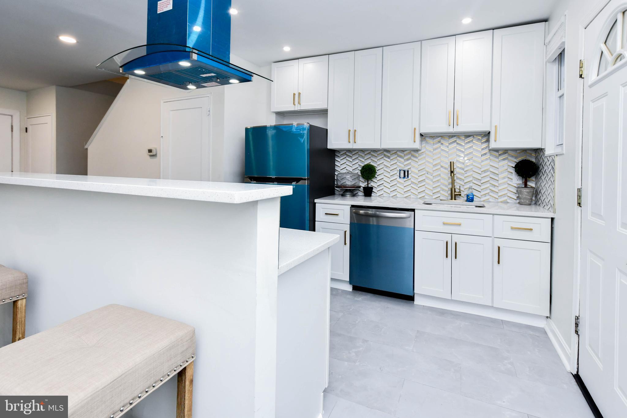 4227 Nash Street Southeast Washington, DC 20020 - Photo 42 of 50 a kitchen with stainless steel appliances granite countertop a sink a stove and a refrigerator