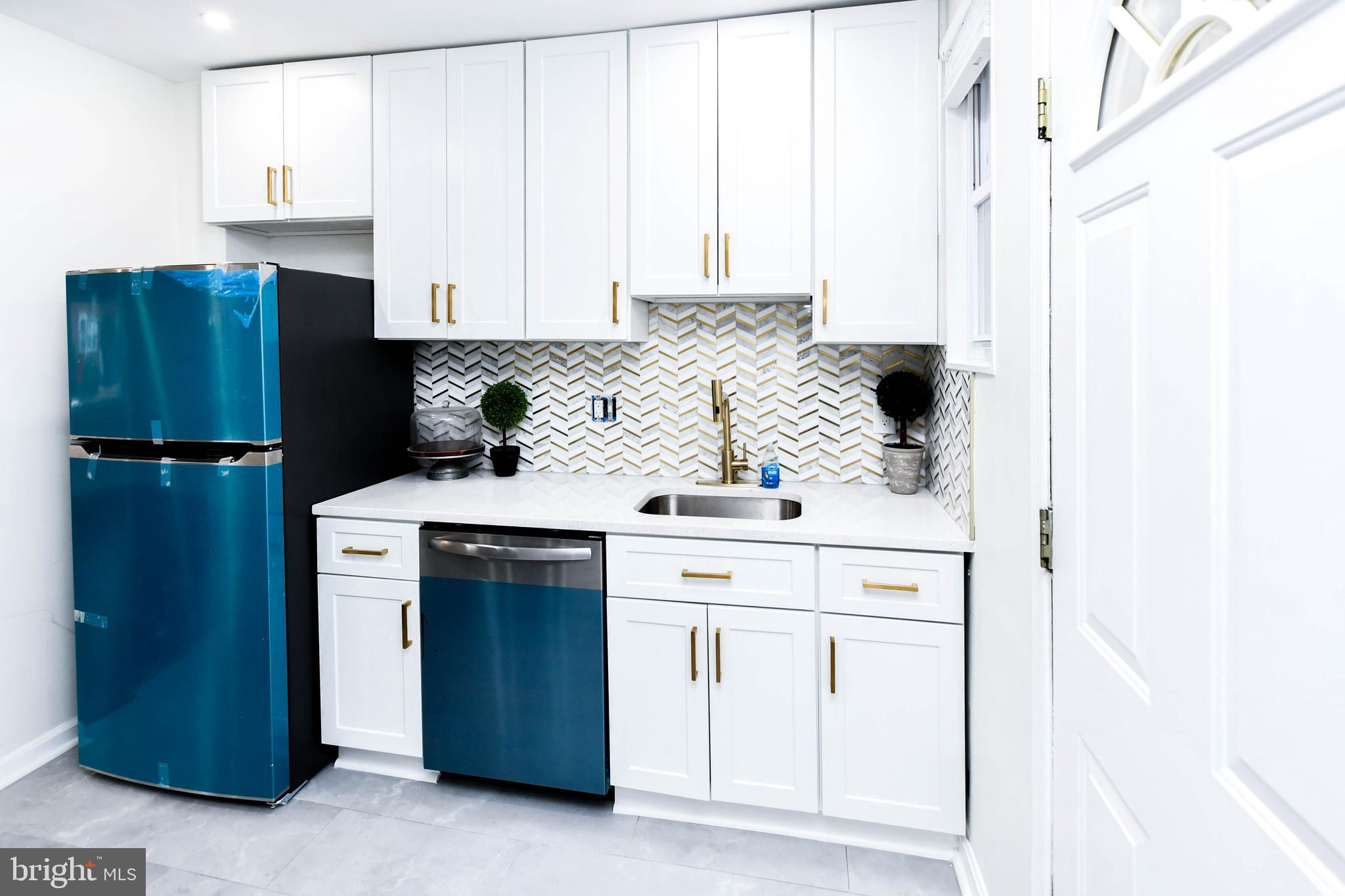 4227 Nash Street Southeast Washington, DC 20020 - Photo 44 of 50 a kitchen with a refrigerator and cabinets