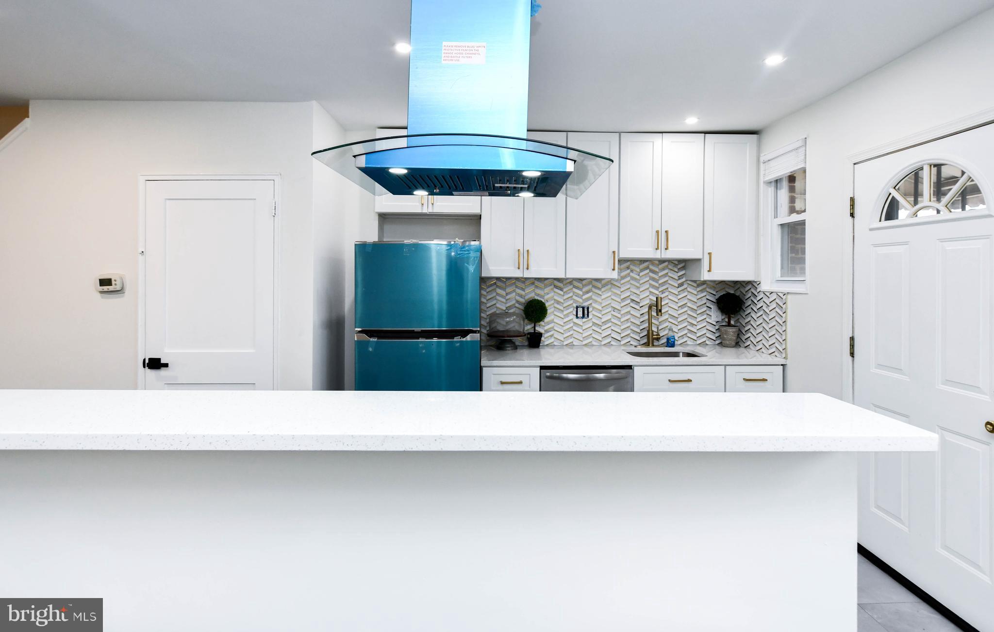 4227 Nash Street Southeast Washington, DC 20020 - Photo 45 of 50 a view of a kitchen with kitchen island a sink stainless steel appliances and cabinets