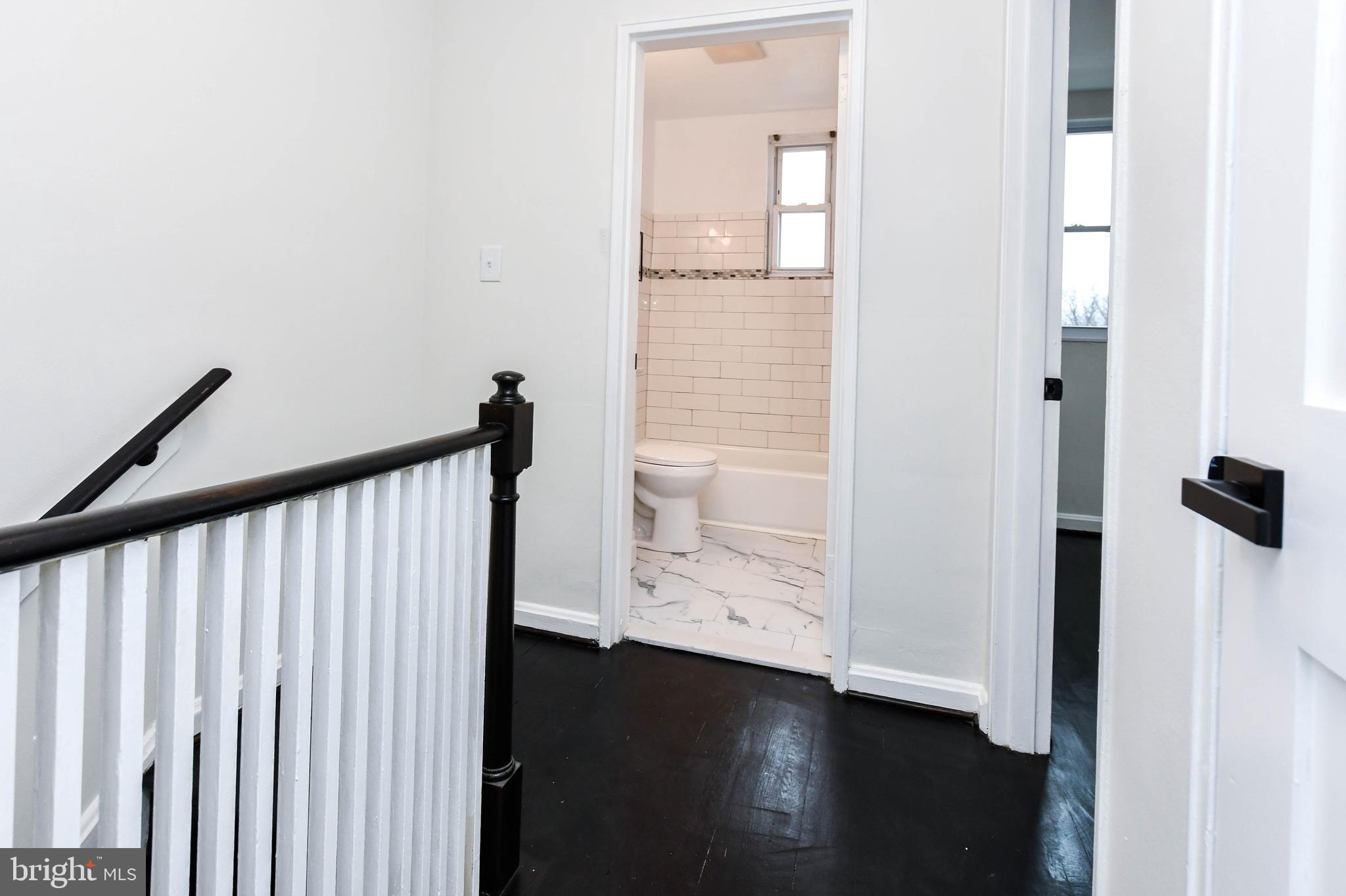 4227 Nash Street Southeast Washington, DC 20020 - Photo 50 of 50 a view of a hallway with wooden floor and staircase