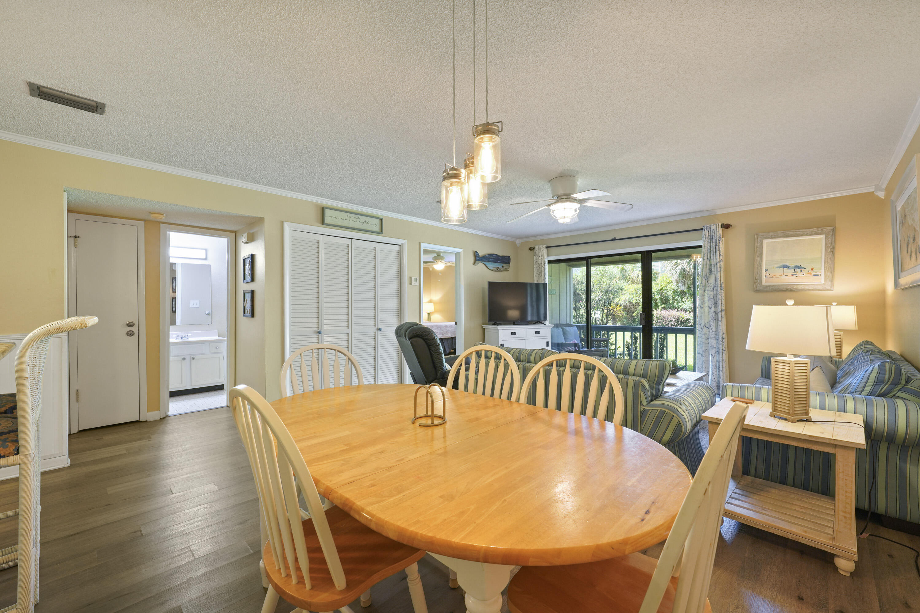 3755 Scenic Highway 98, Unit 1601 Destin, FL 32541 - Photo 12 of 50 a view of a dining room with furniture and wooden floor