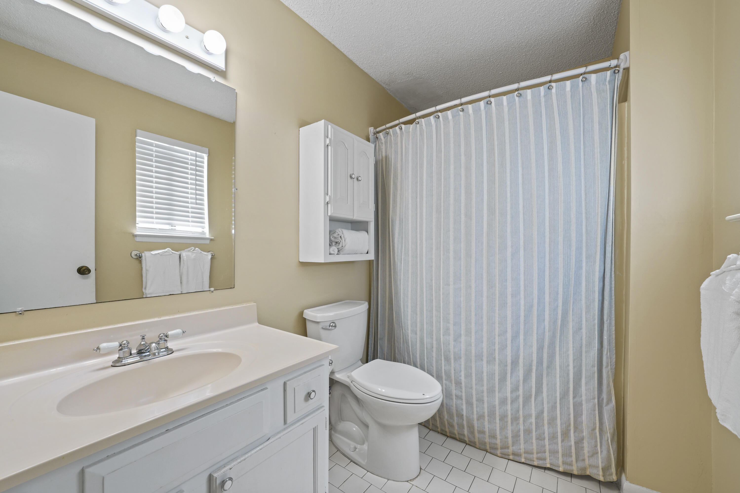 3755 Scenic Highway 98, Unit 1601 Destin, FL 32541 - Photo 27 of 50 a bathroom with a sink a toilet and mirror