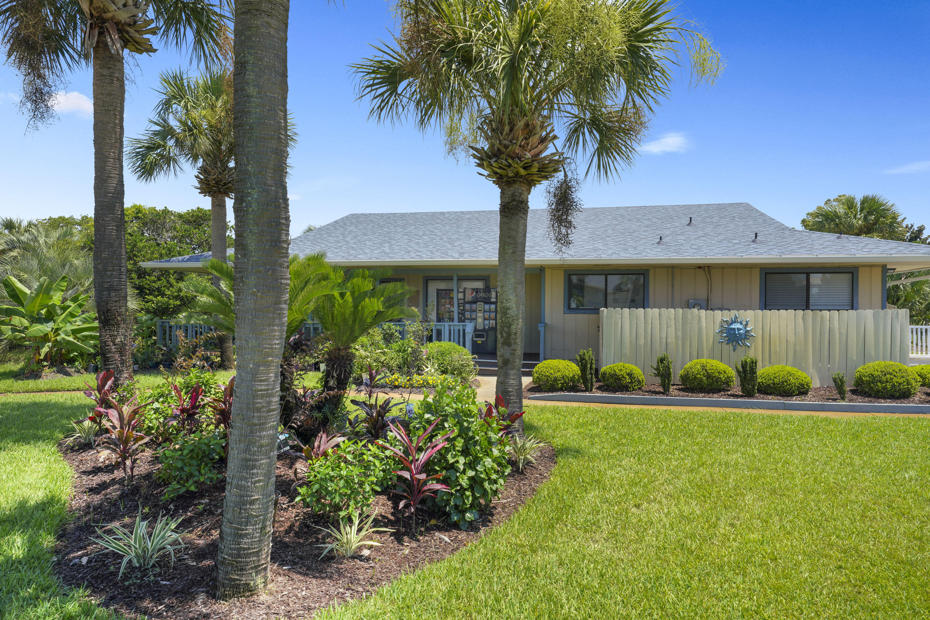 3755 Scenic Highway 98, Unit 1601 Destin, FL 32541 - Photo 38 of 50 a front view of a house with a yard and potted plants