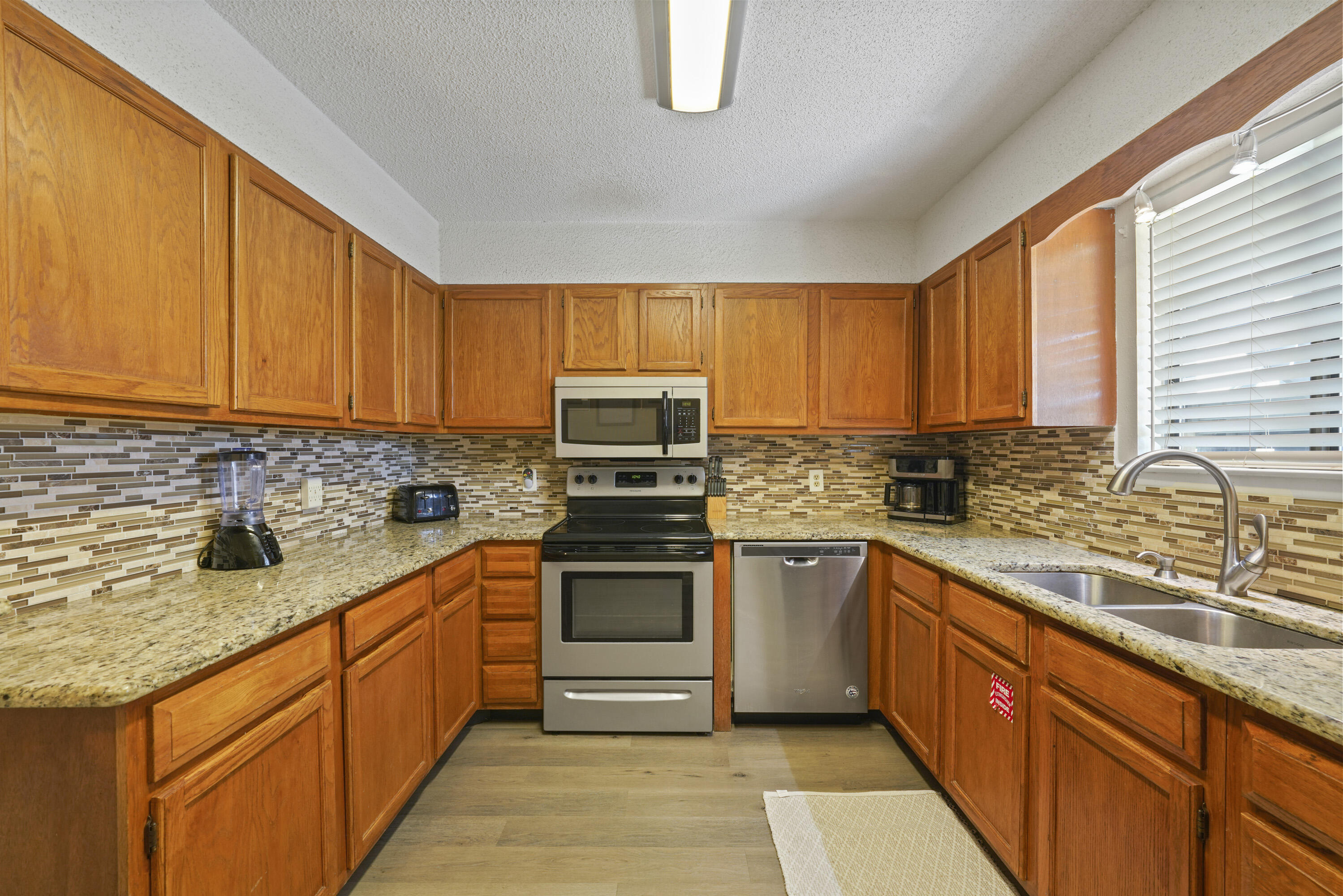 3755 Scenic Highway 98, Unit 1601 Destin, FL 32541 - Photo 6 of 50 a kitchen with stainless steel appliances granite countertop a sink stove and refrigerator