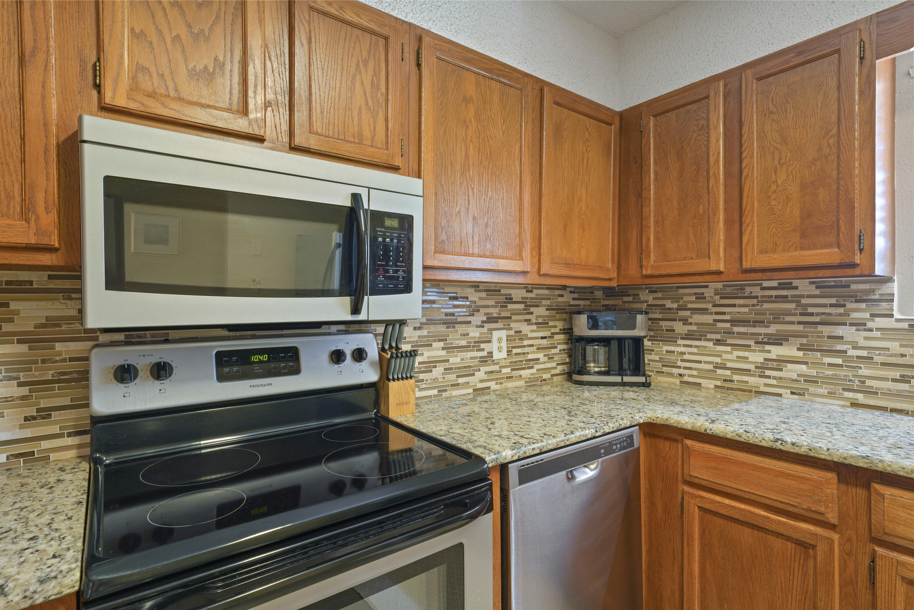 3755 Scenic Highway 98, Unit 1601 Destin, FL 32541 - Photo 7 of 50 a kitchen with stainless steel appliances granite countertop a sink stove and microwave