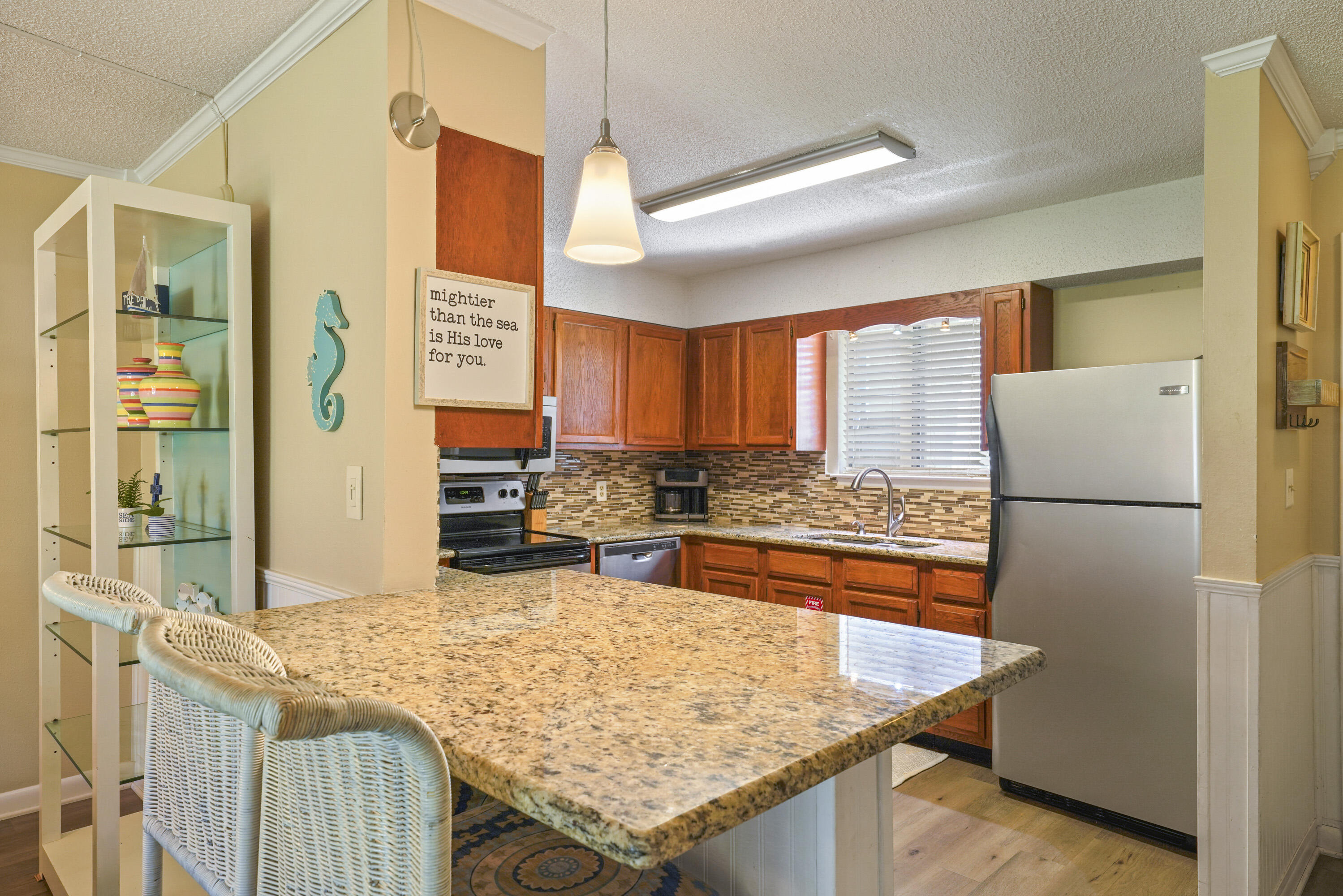 3755 Scenic Highway 98, Unit 1601 Destin, FL 32541 - Photo 10 of 50 a kitchen with stainless steel appliances granite countertop wooden floor window and refrigerator