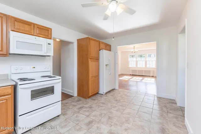 a kitchen with a stove a refrigerator and a cabinets