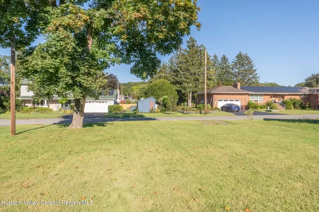 a front view of a building with trees