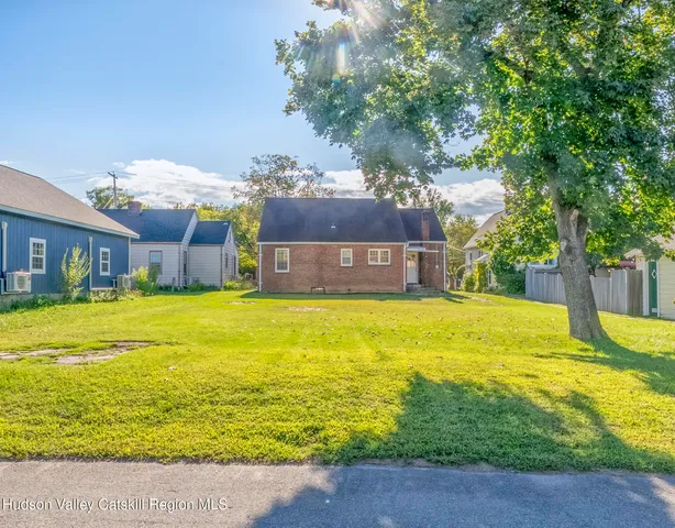 a swimming pool with outdoor seating and yard