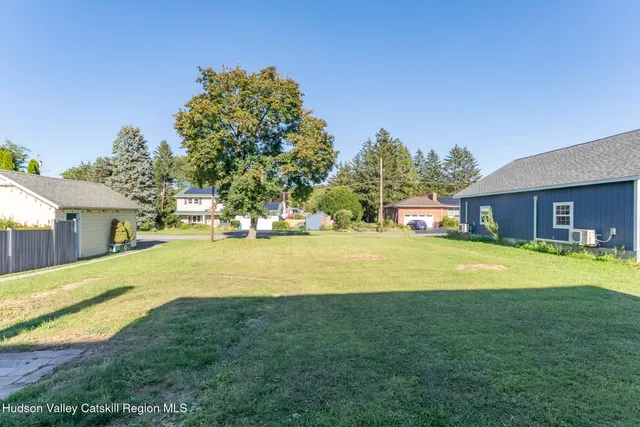 a house view with swimming pool in front of it