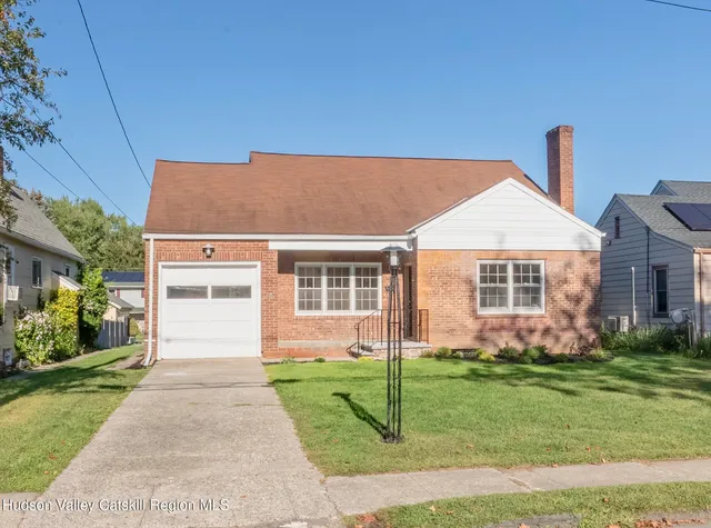 a front view of house with yard and green space
