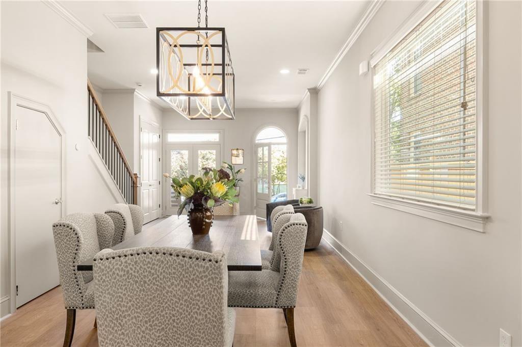 722 Lakeview Avenue Northeast, Unit A Atlanta, GA 30308 - Photo 11 of 48 a dining room with furniture a potted plant and wooden floor