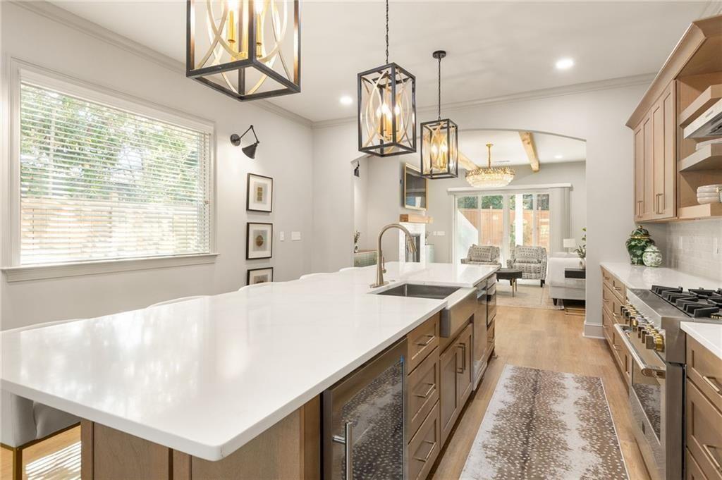 722 Lakeview Avenue Northeast, Unit A Atlanta, GA 30308 - Photo 14 of 48 a kitchen with kitchen island a stove a sink a refrigerator and windows