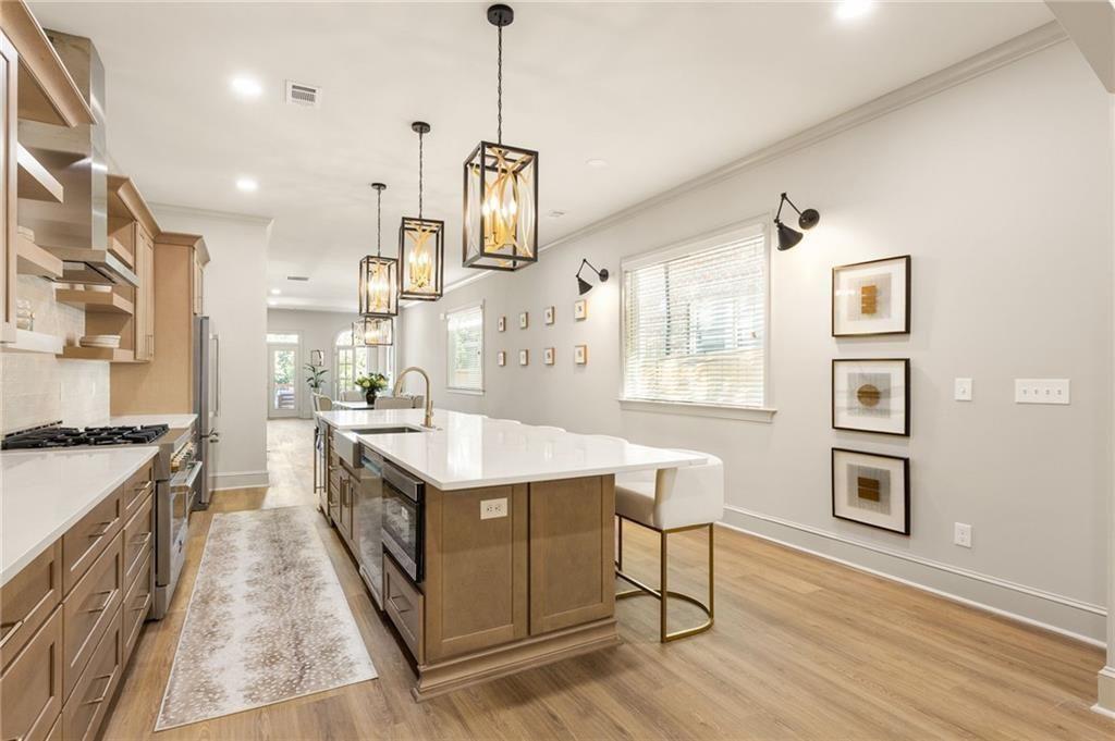 722 Lakeview Avenue Northeast, Unit A Atlanta, GA 30308 - Photo 16 of 48 a kitchen with stainless steel appliances granite countertop a sink stove and wooden floor