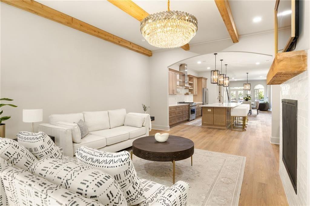 722 Lakeview Avenue Northeast, Unit A Atlanta, GA 30308 - Photo 17 of 48 a living room with furniture a dining table and a chandelier