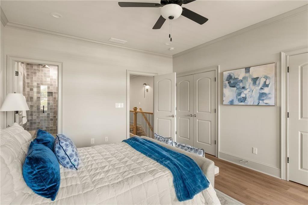 722 Lakeview Avenue Northeast, Unit A Atlanta, GA 30308 - Photo 23 of 48 a bedroom with a large bed and a chandelier