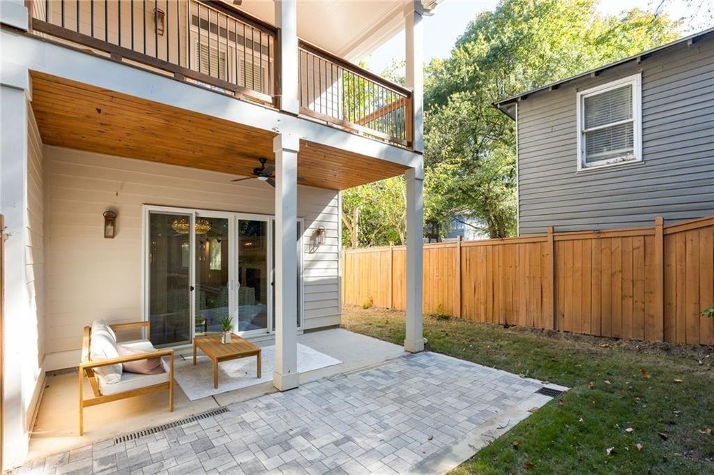 722 Lakeview Avenue Northeast, Unit A Atlanta, GA 30308 - Photo 36 of 48 a view of a patio with table and chairs and wooden fence