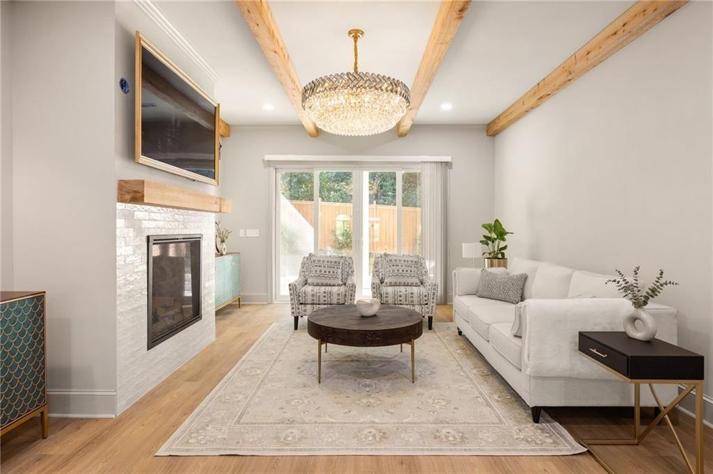 722 Lakeview Avenue Northeast, Unit A Atlanta, GA 30308 - Photo 4 of 48 a living room with a couch a fireplace and a large window