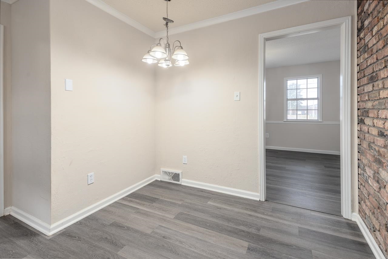 2718 Kate Bond Road Memphis, TN 38133 - Photo 11 of 39 wooden floor in an empty room with a window