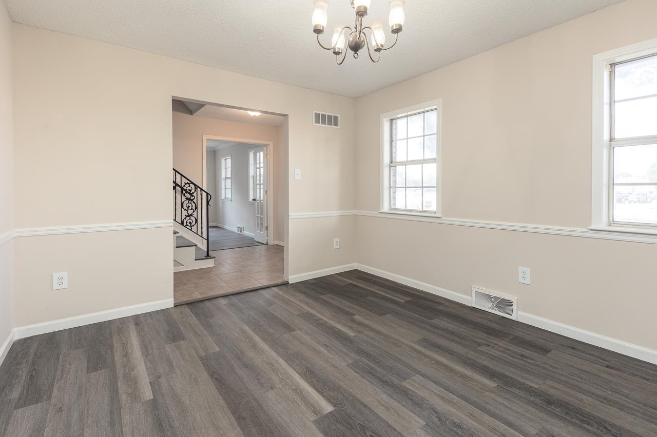 2718 Kate Bond Road Memphis, TN 38133 - Photo 12 of 39 an empty room with wooden floor and windows