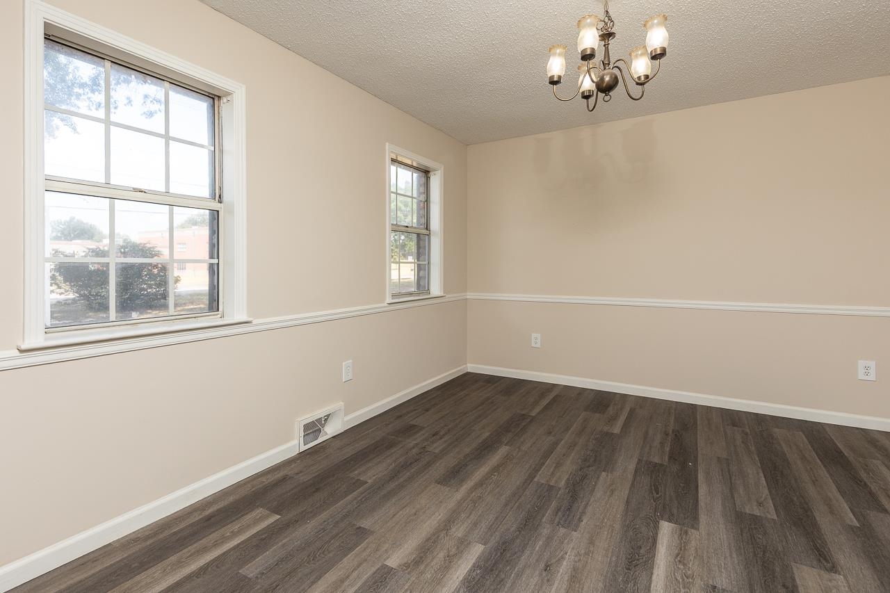 2718 Kate Bond Road Memphis, TN 38133 - Photo 13 of 39 wooden floor in an empty room with a window