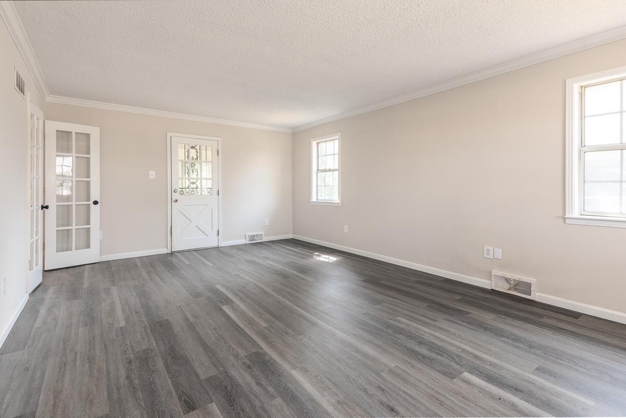 2718 Kate Bond Road Memphis, TN 38133 - Photo 16 of 39 an empty room with wooden floor and windows