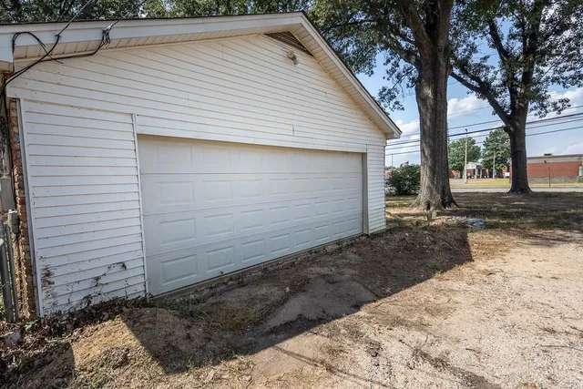 a front view of house with yard and trees