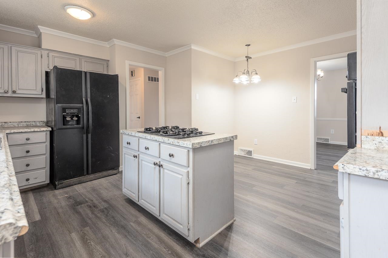2718 Kate Bond Road Memphis, TN 38133 - Photo 6 of 39 a kitchen with stainless steel appliances a refrigerator and a stove top oven