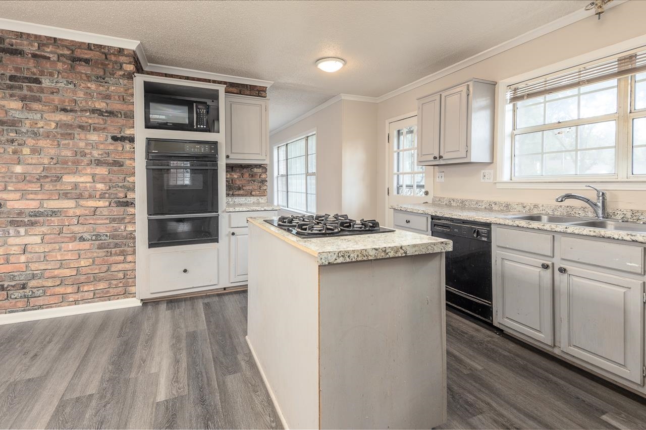 2718 Kate Bond Road Memphis, TN 38133 - Photo 9 of 39 a kitchen with a sink stove and cabinets
