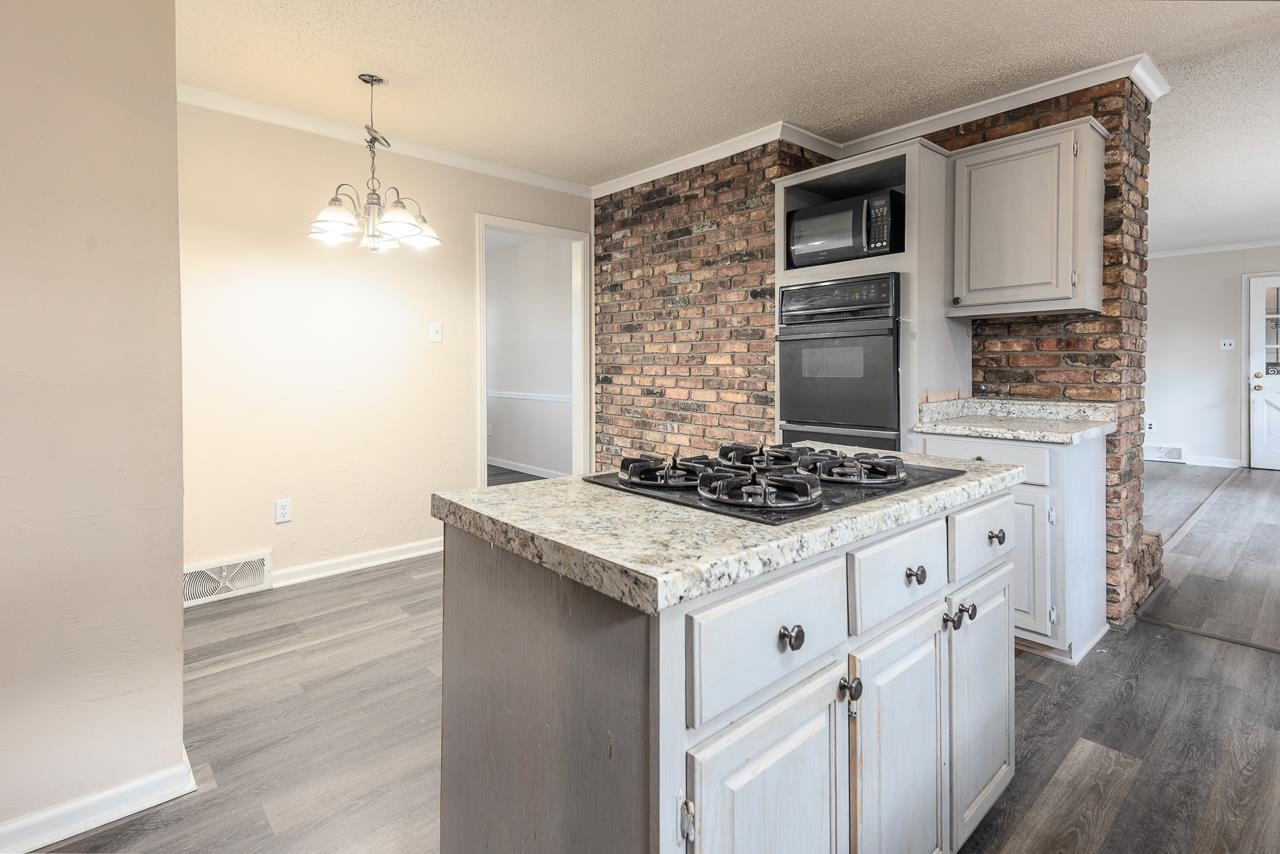 2718 Kate Bond Road Memphis, TN 38133 - Photo 10 of 39 a kitchen with granite countertop a stove and a sink