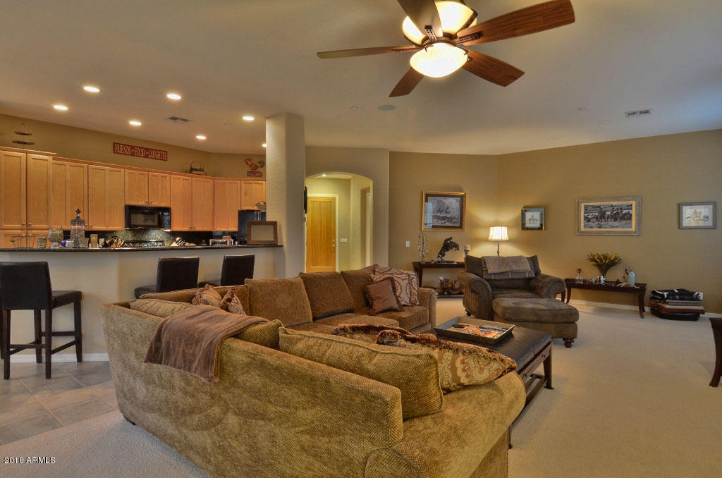 11475 East Helm Drive Scottsdale, AZ 85255 - Photo 11 of 35 a living room with furniture and a view of kitchen
