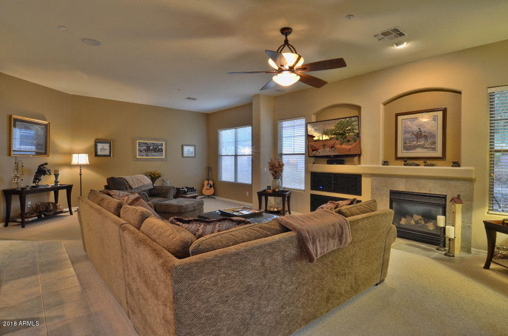 11475 East Helm Drive Scottsdale, AZ 85255 - Photo 12 of 35 a living room with fireplace furniture and a chandelier