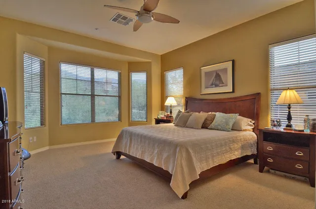 a bedroom with a bed dresser and a window