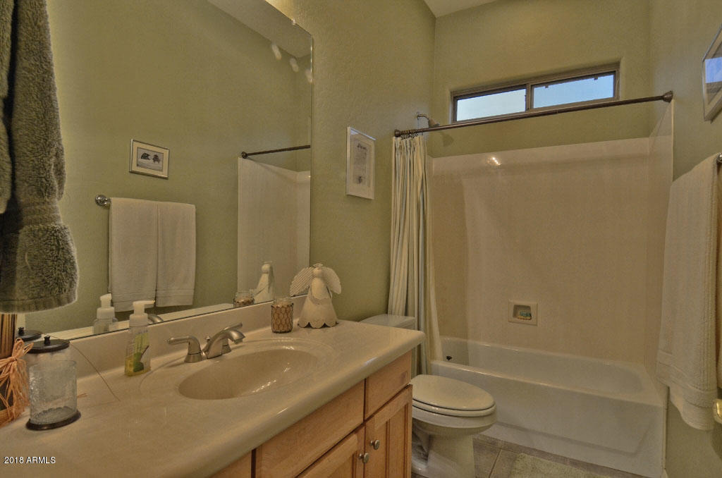 11475 East Helm Drive Scottsdale, AZ 85255 - Photo 17 of 35 a bathroom with a sink toilet and shower
