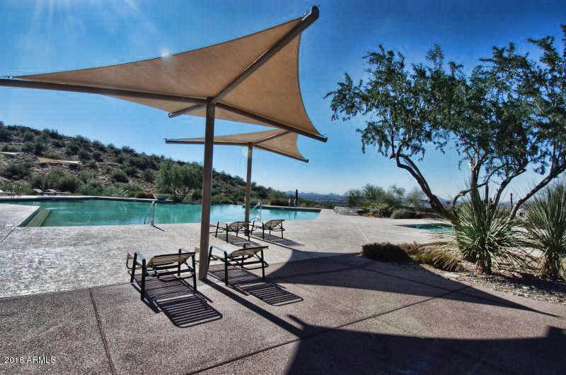 11475 East Helm Drive Scottsdale, AZ 85255 - Photo 29 of 35 a view of a lake with a table and chairs under an umbrella