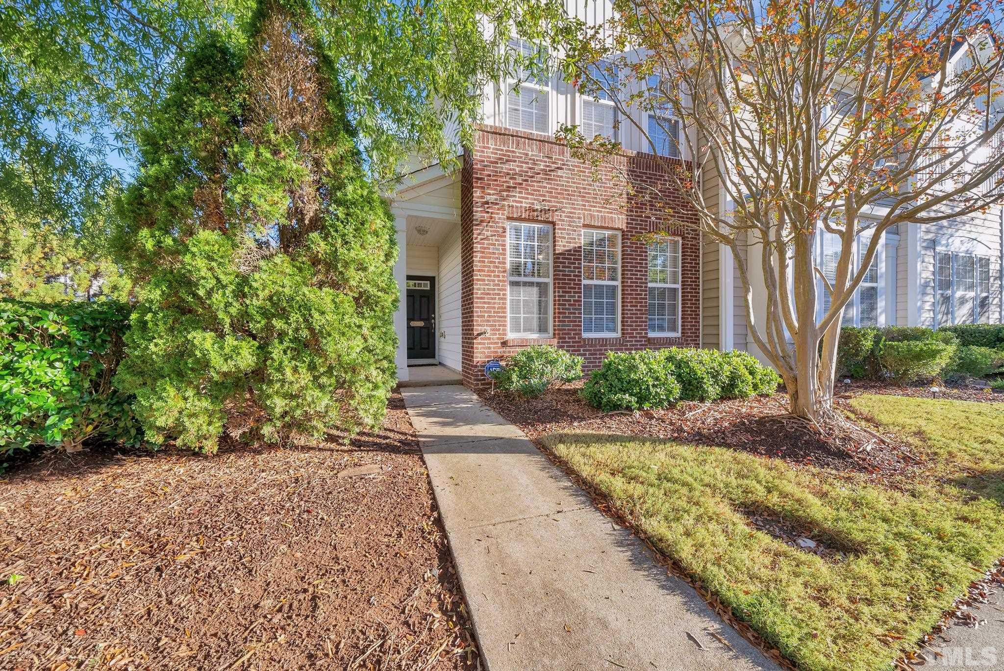 7618 Winners Edge Street Raleigh, NC 27617 - Photo 1 of 22 a view of a brick building next to a yard