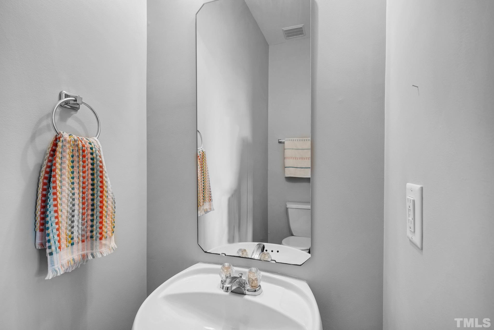 7618 Winners Edge Street Raleigh, NC 27617 - Photo 12 of 22 a bathroom with a sink and a mirror