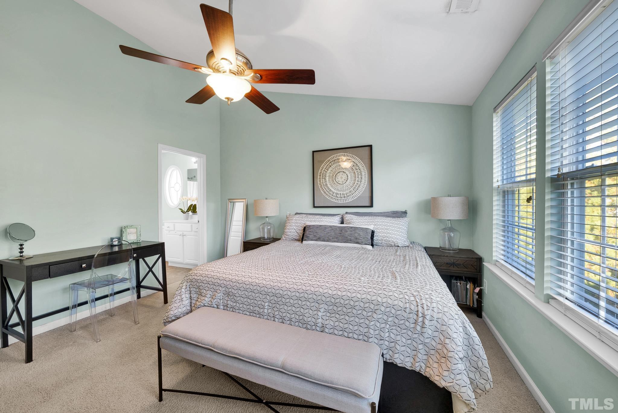 7618 Winners Edge Street Raleigh, NC 27617 - Photo 14 of 22 a bedroom with a bed and a chandelier
