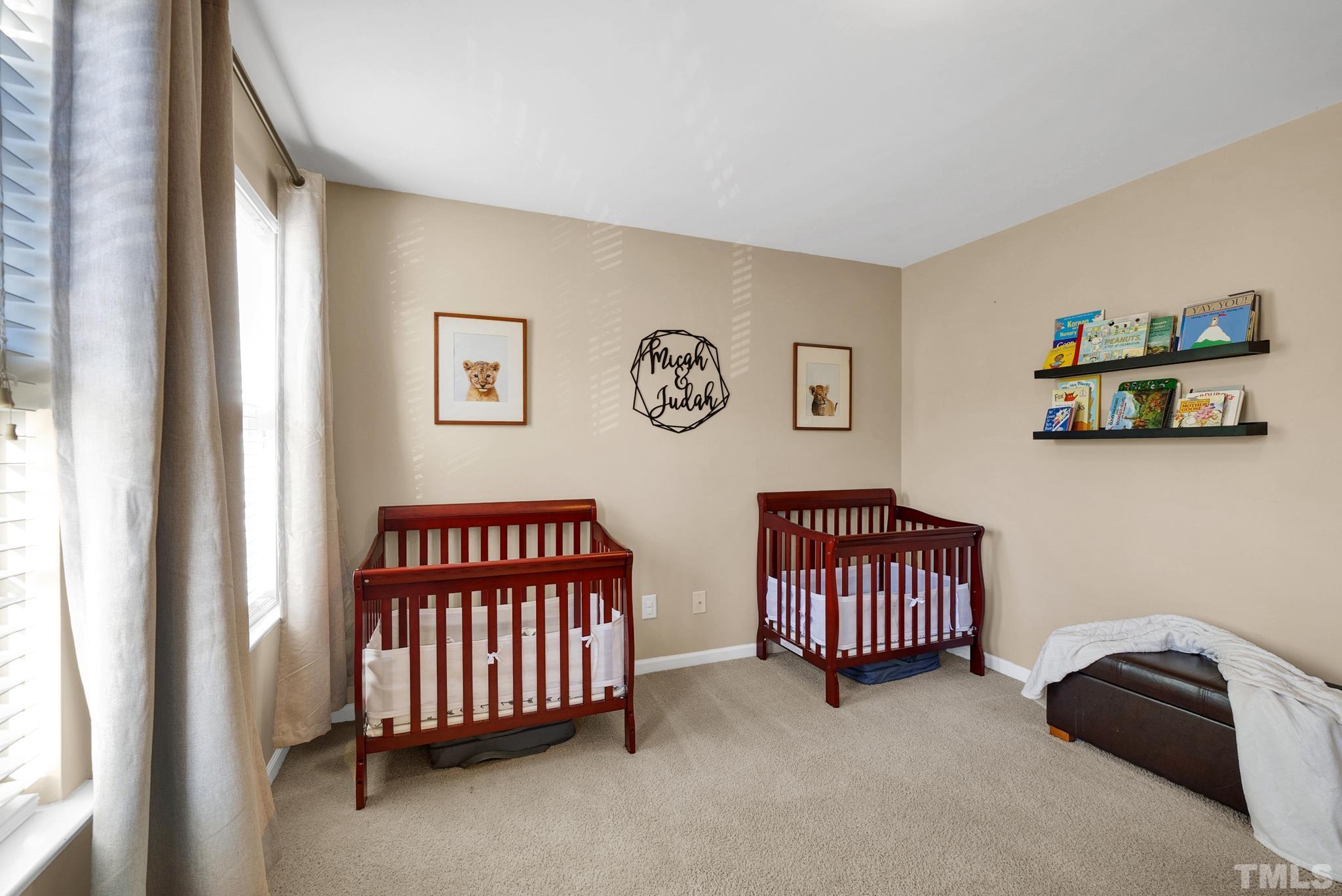 7618 Winners Edge Street Raleigh, NC 27617 - Photo 17 of 22 a bedroom with a bed and a window