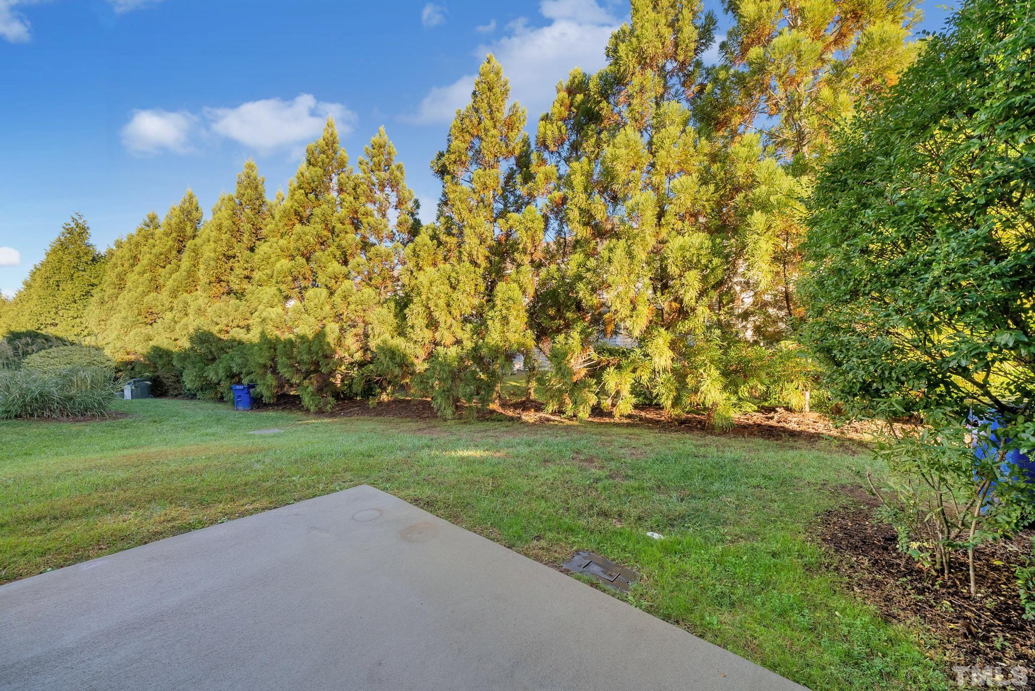 7618 Winners Edge Street Raleigh, NC 27617 - Photo 19 of 22 a view of a grassy field with trees