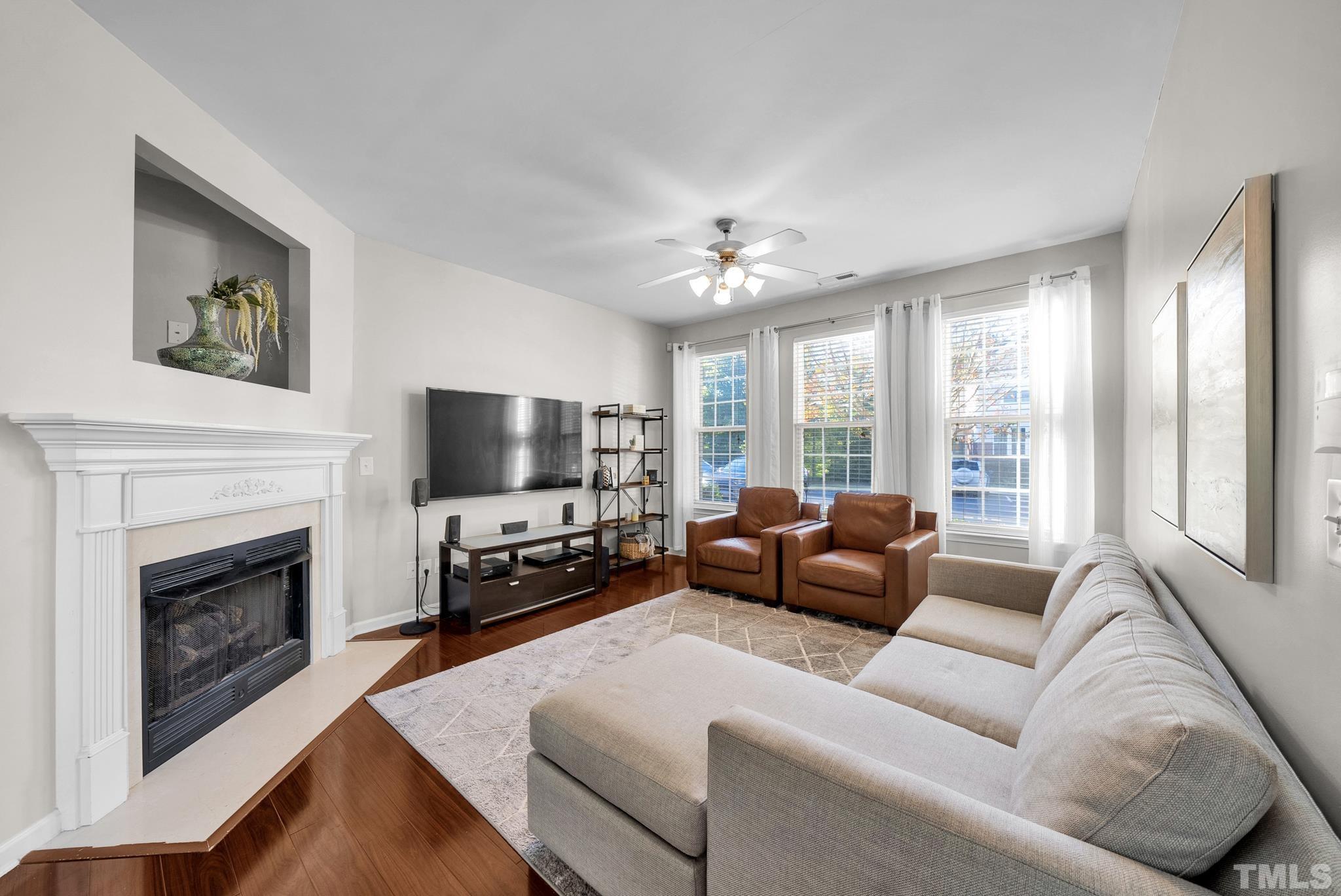 7618 Winners Edge Street Raleigh, NC 27617 - Photo 3 of 22 a living room with furniture fireplace and flat screen tv