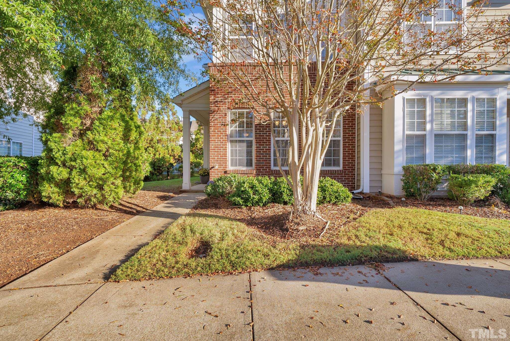 7618 Winners Edge Street Raleigh, NC 27617 - Photo 21 of 22 a front view of a house with garden